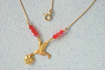collier colilbri-hibiscus.Or 750/1000